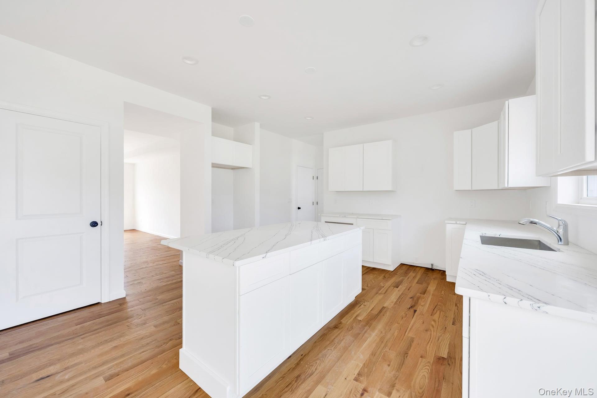 Lot #4 Cardinal Court Ridge, NY 11961 - Photo 26 of 48 a kitchen with cabinets and wooden floor