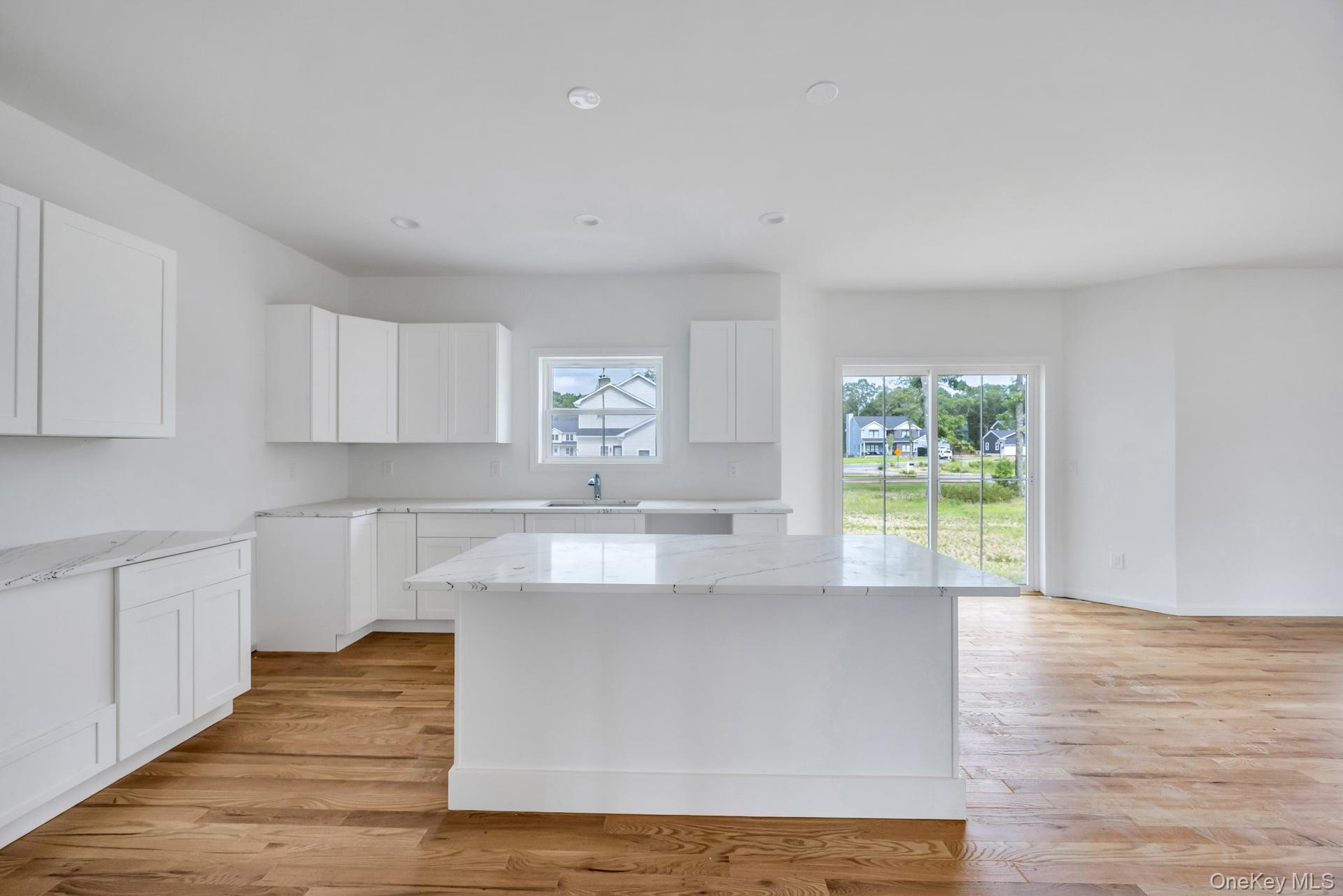 Lot #4 Cardinal Court Ridge, NY 11961 - Photo 27 of 48 a kitchen with stainless steel appliances granite countertop a stove a sink and a wooden floors