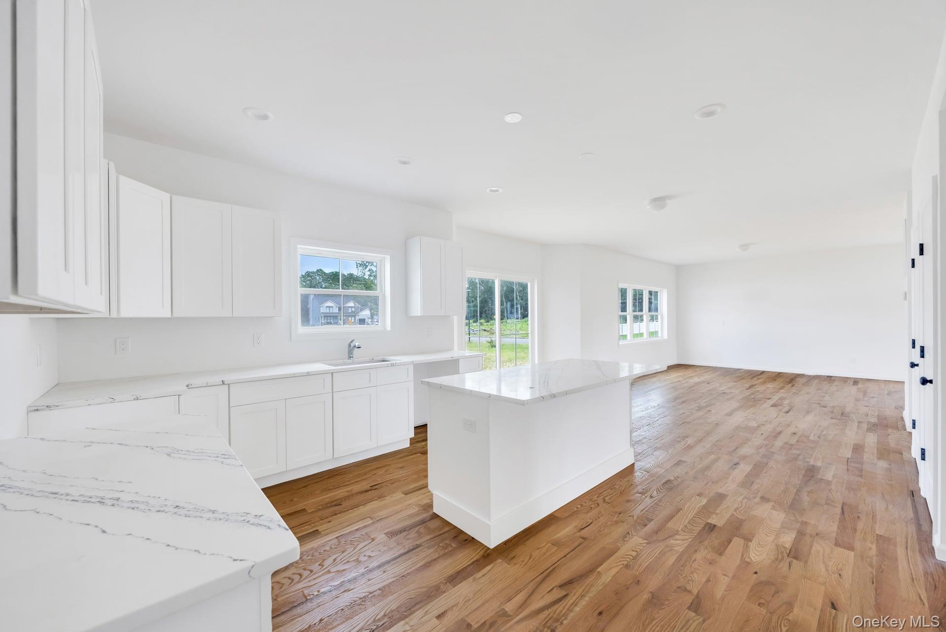 Lot #4 Cardinal Court Ridge, NY 11961 - Photo 28 of 48 a room with wooden floors and white walls