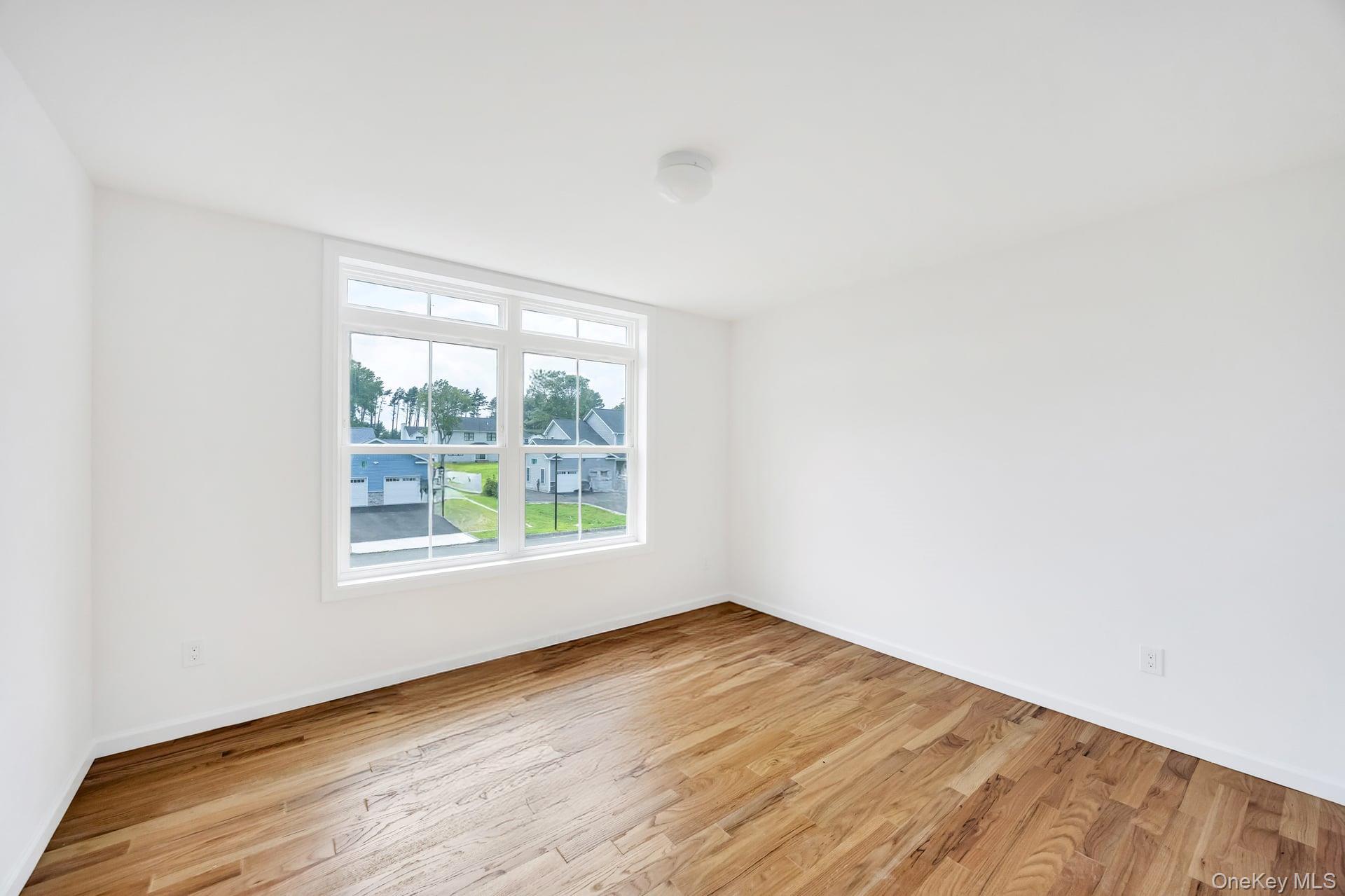 Lot #4 Cardinal Court Ridge, NY 11961 - Photo 34 of 48 an empty room with wooden floor and windows
