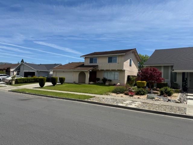 a view of house with outdoor space and parking