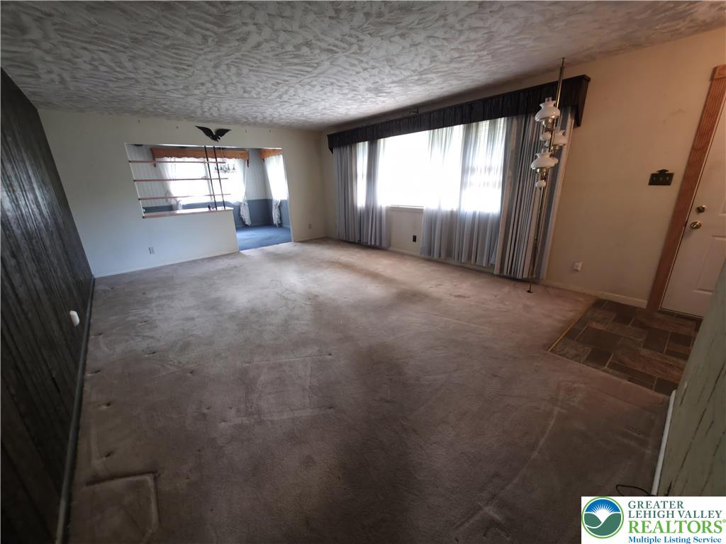 50 Montovision Road Mount Pocono, PA 18344 - Photo 6 of 32 Discover a welcoming living room with plush carpeting and ample natural light.