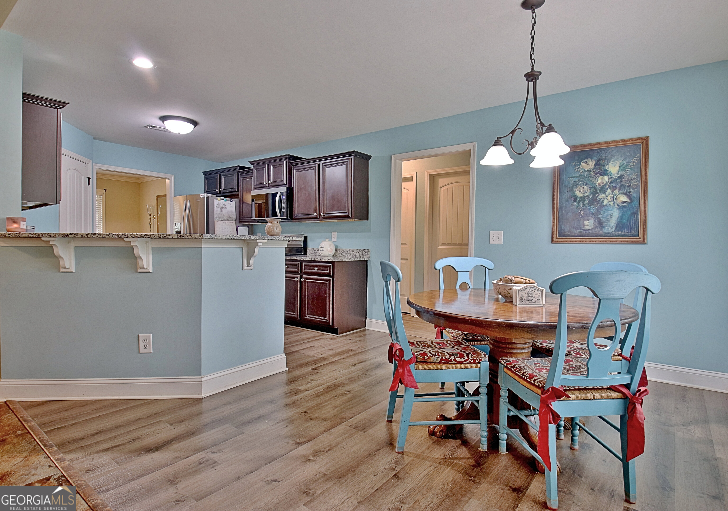96 East Gordon Road Newnan, GA 30263 - Photo 11 of 34 a kitchen with stainless steel appliances a dining table chairs and stove