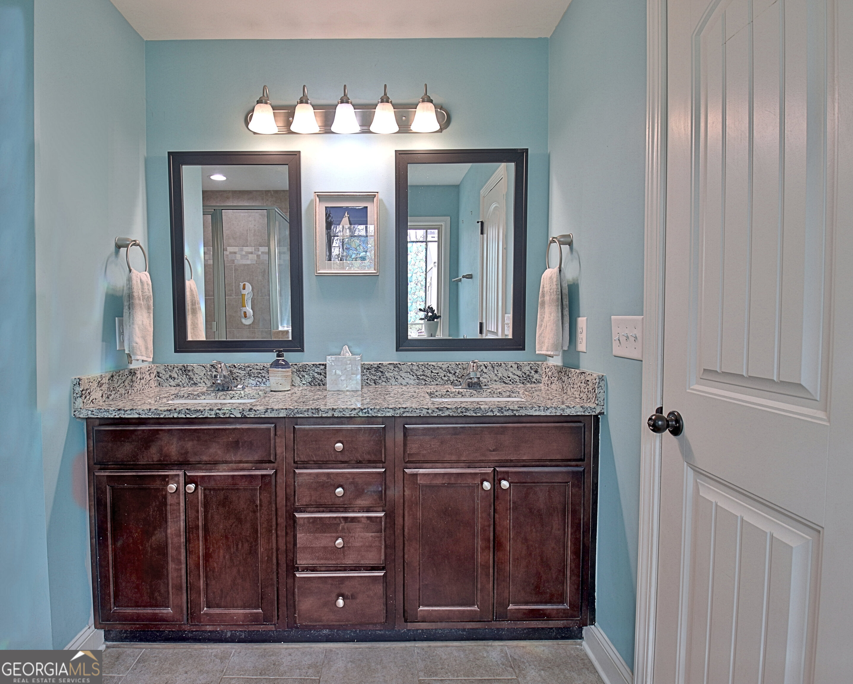 96 East Gordon Road Newnan, GA 30263 - Photo 19 of 34 a bathroom with a granite countertop sink a large mirror and a wooden cabinets