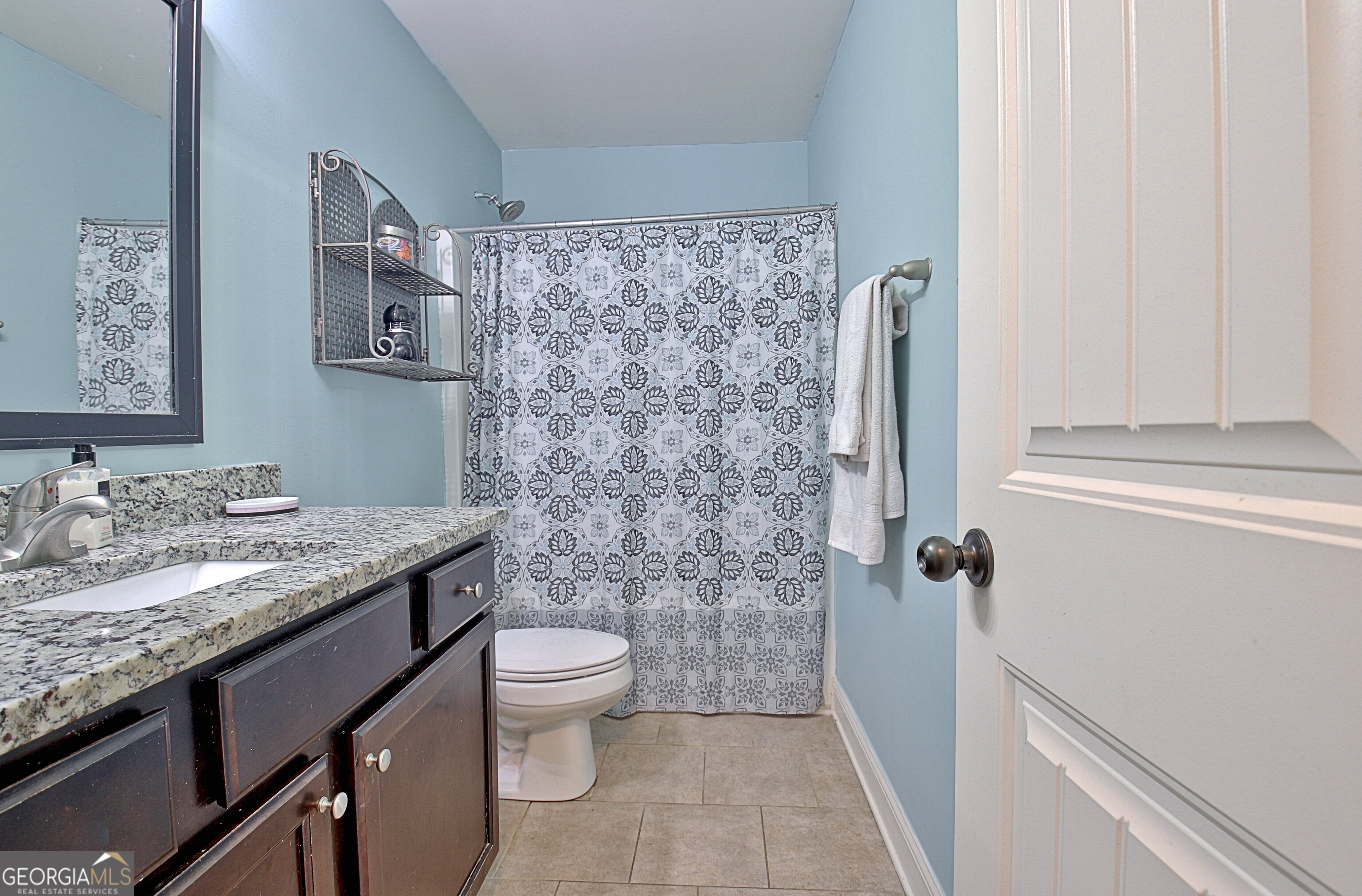 96 East Gordon Road Newnan, GA 30263 - Photo 23 of 34 a bathroom with a granite countertop sink toilet and shower