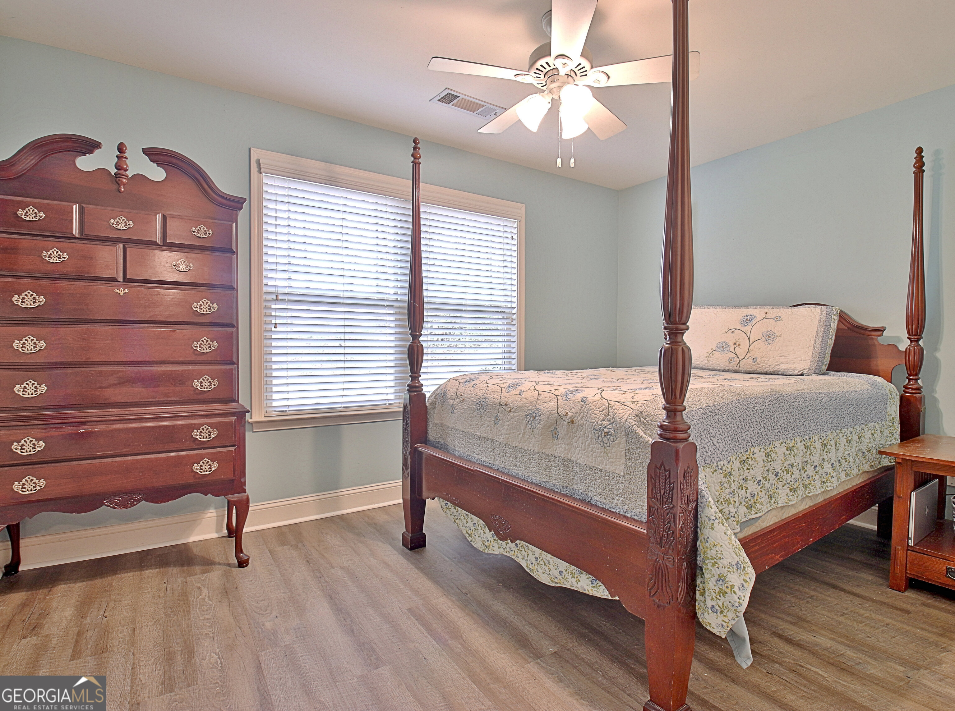 96 East Gordon Road Newnan, GA 30263 - Photo 26 of 34 a bedroom with a bed and a chandelier