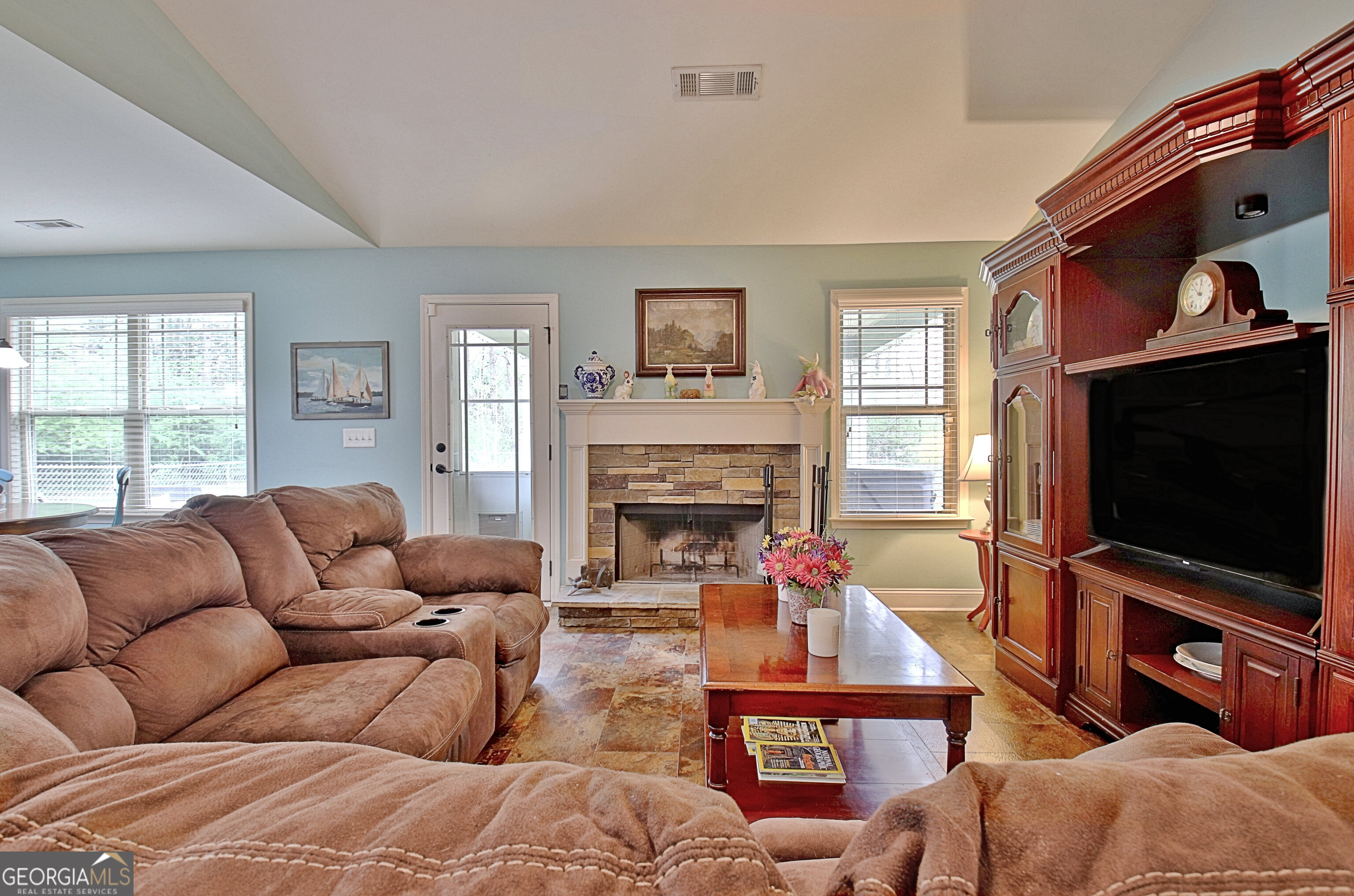 96 East Gordon Road Newnan, GA 30263 - Photo 8 of 34 a living room with furniture a flat screen tv and a fireplace