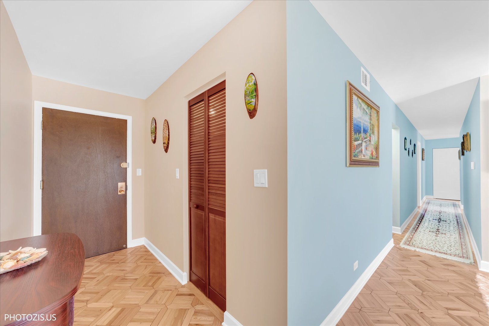 4900 Foster Street, Unit 412 Skokie, IL 60077 - Photo 4 of 32 a view of a hallway with wooden floor and a living room