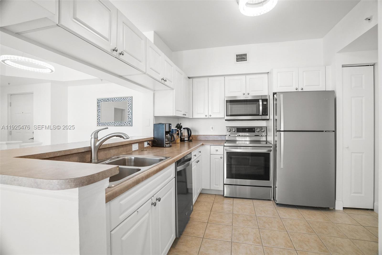 17150 North Bay Road, Unit 2706 Sunny Isles Beach, FL 33160 - Photo 12 of 47 a kitchen with a sink appliances and cabinets