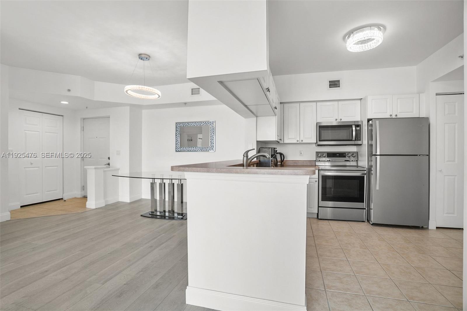 17150 North Bay Road, Unit 2706 Sunny Isles Beach, FL 33160 - Photo 13 of 47 a kitchen with stainless steel appliances a refrigerator and a stove top oven