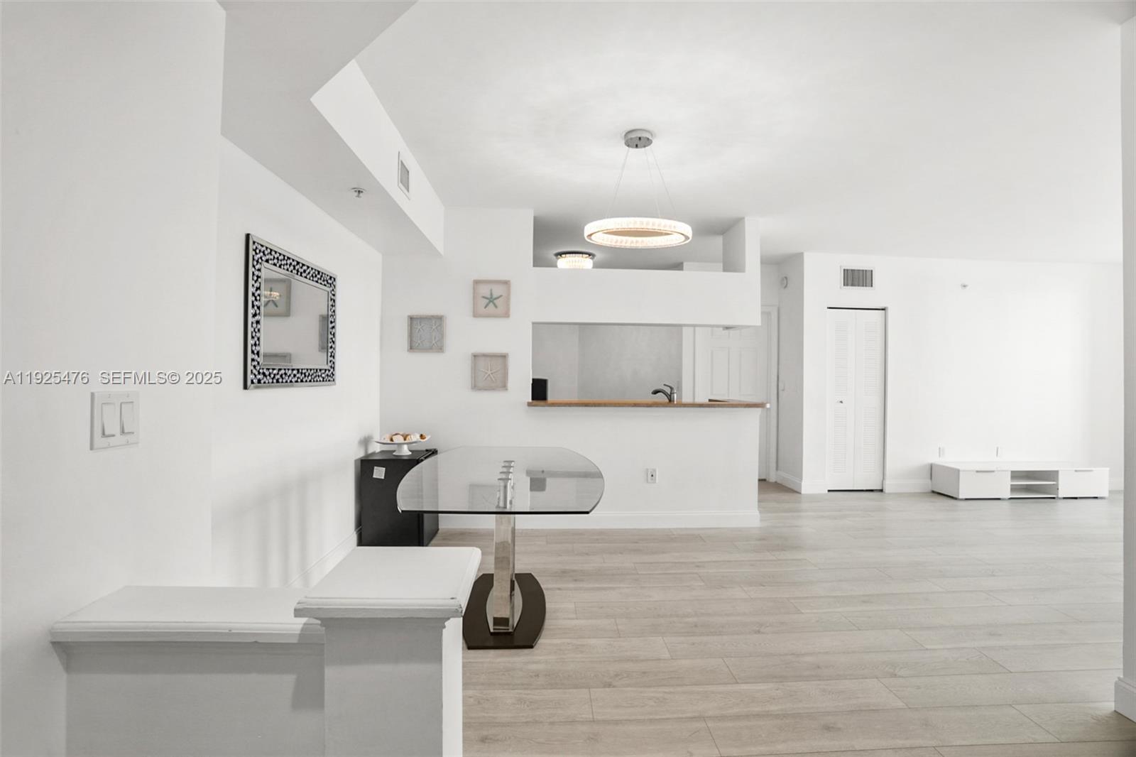 17150 North Bay Road, Unit 2706 Sunny Isles Beach, FL 33160 - Photo 17 of 47 a view of kitchen with furniture and wooden floor