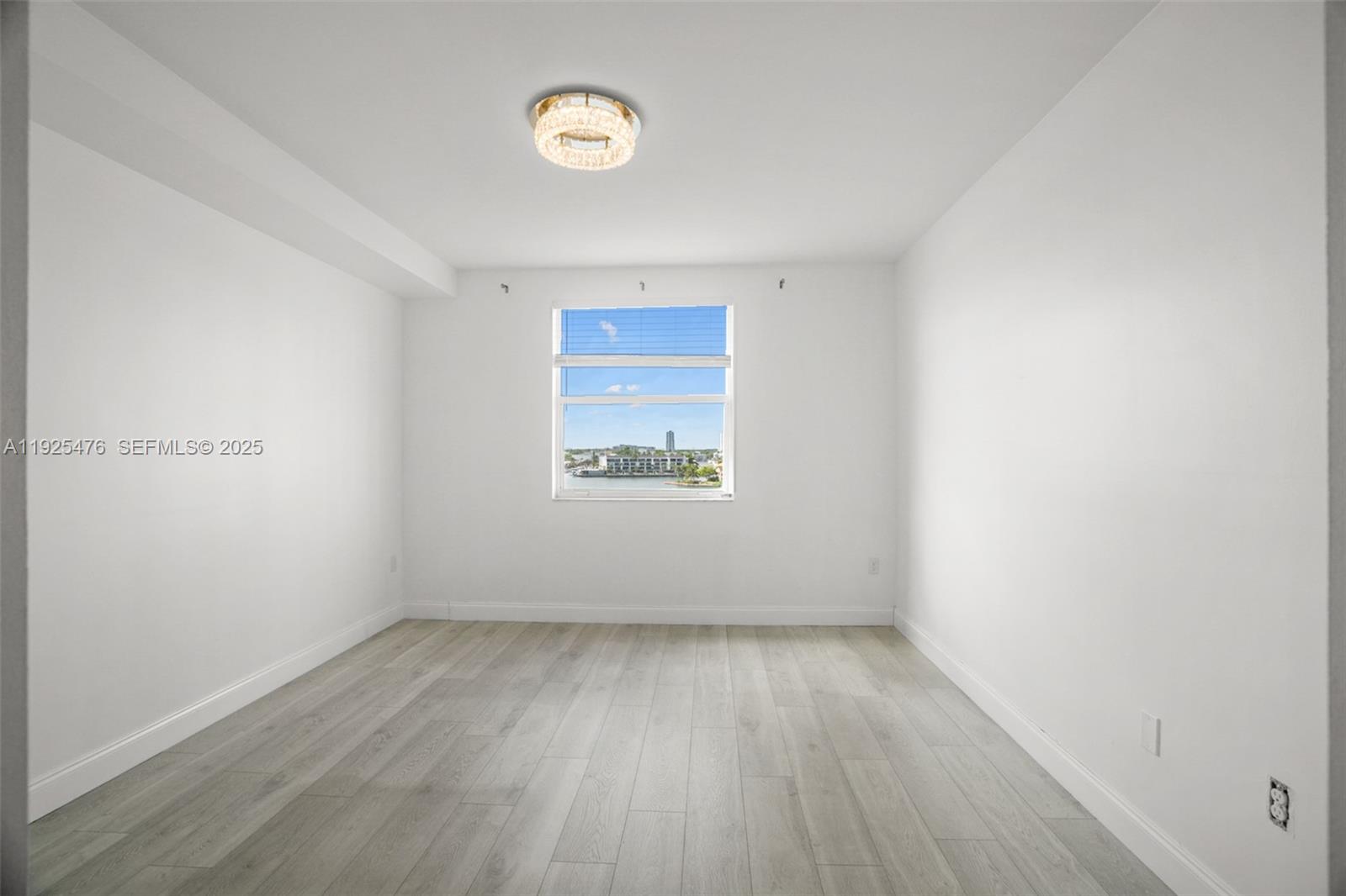 17150 North Bay Road, Unit 2706 Sunny Isles Beach, FL 33160 - Photo 19 of 47 an empty room with a window