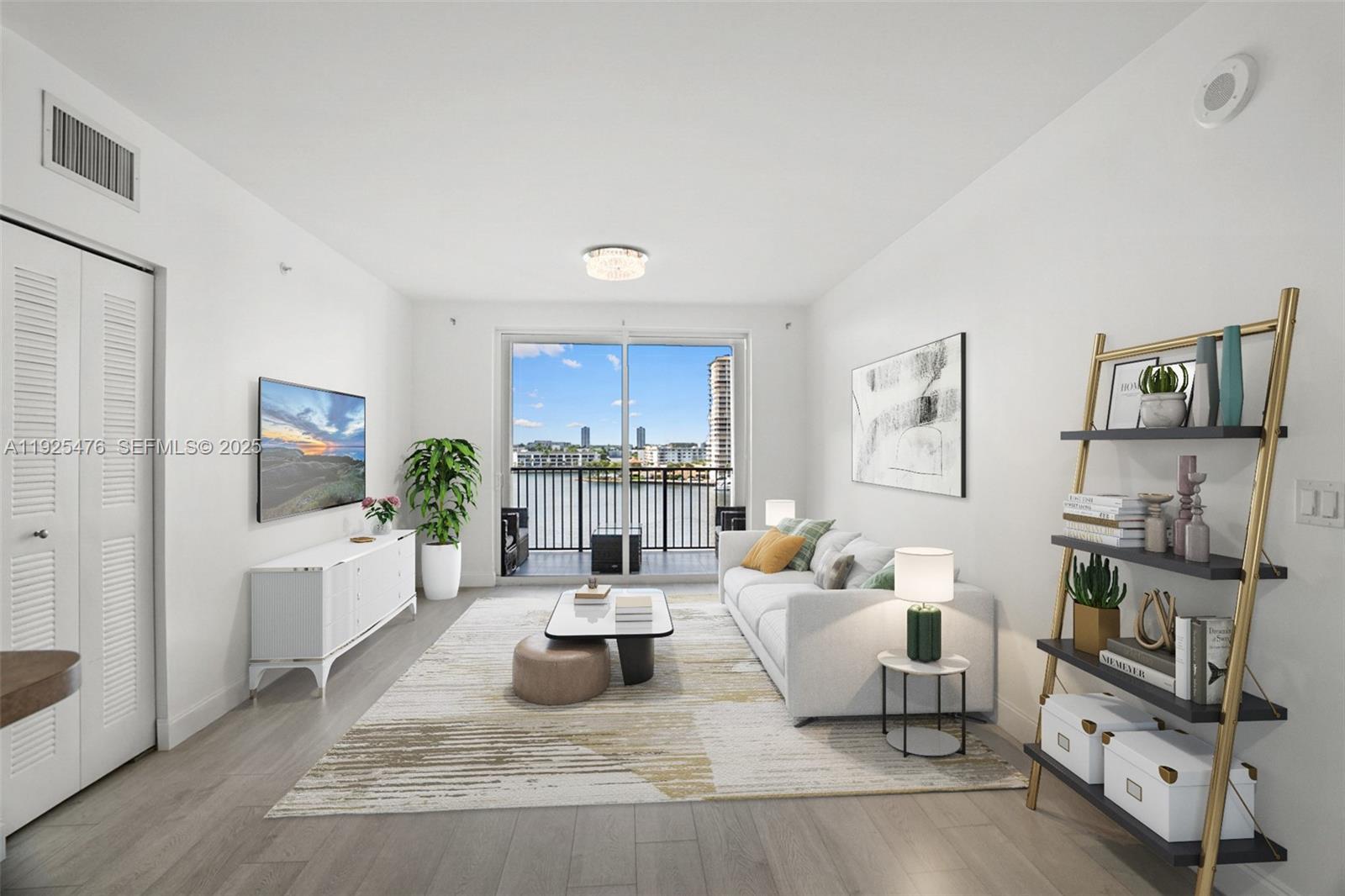 17150 North Bay Road, Unit 2706 Sunny Isles Beach, FL 33160 - Photo 2 of 47 a living room with furniture and a flat screen tv