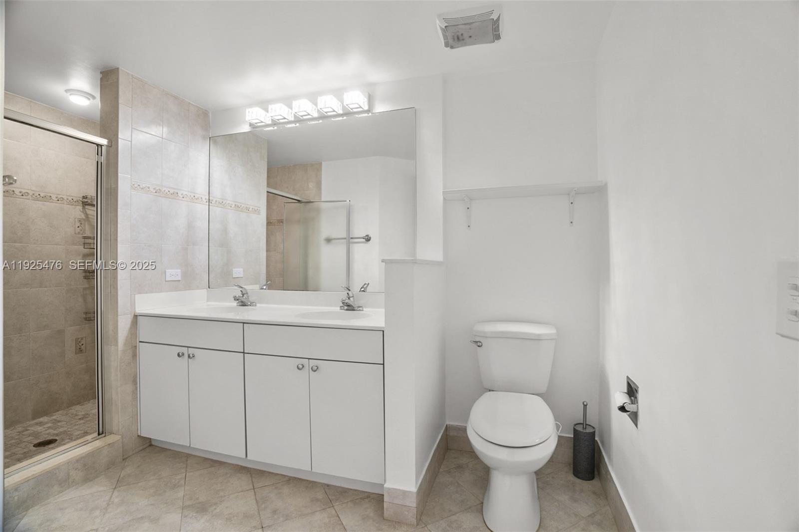 17150 North Bay Road, Unit 2706 Sunny Isles Beach, FL 33160 - Photo 21 of 47 a bathroom with a toilet sink and mirror