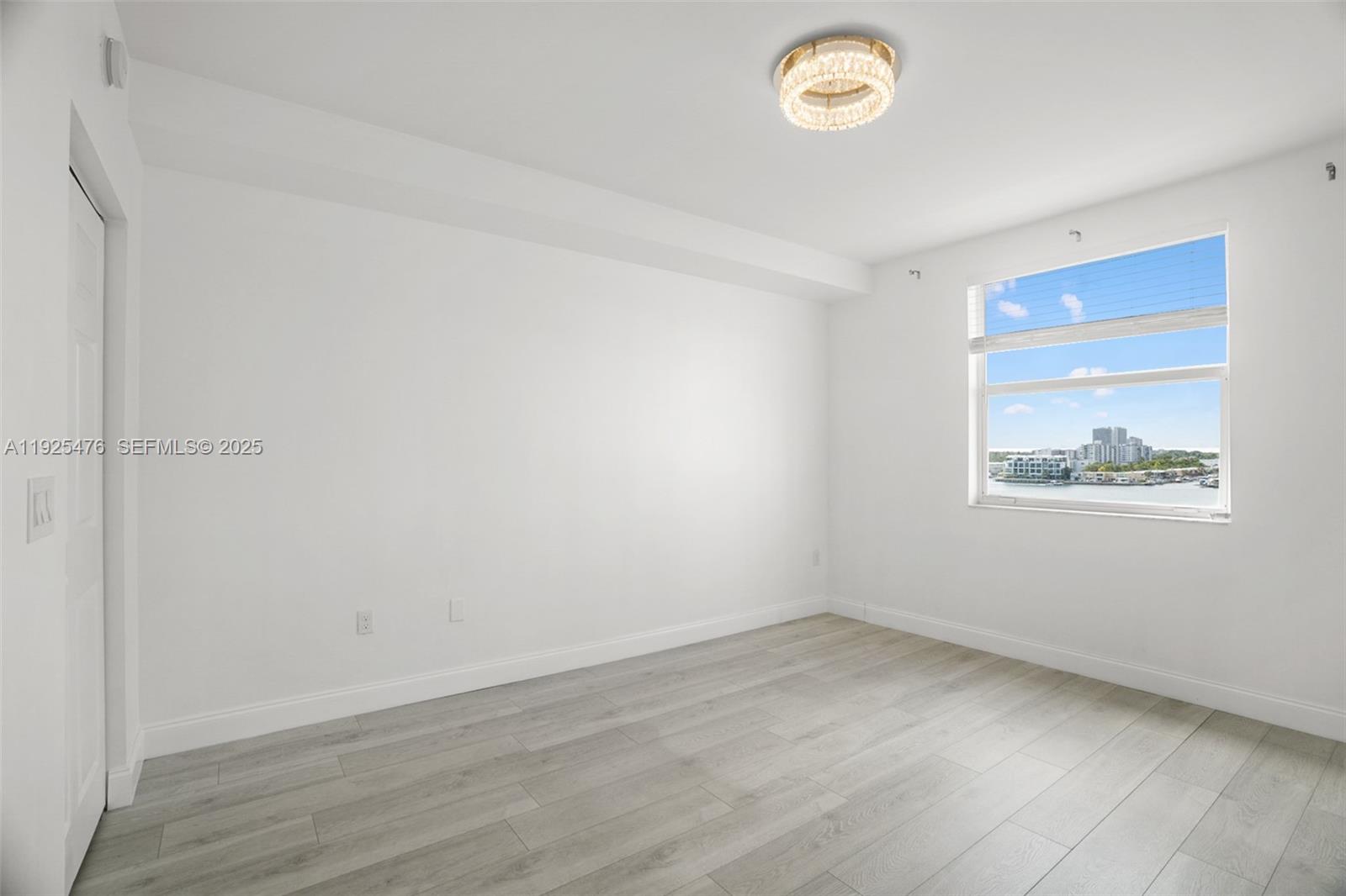 17150 North Bay Road, Unit 2706 Sunny Isles Beach, FL 33160 - Photo 22 of 47 an empty room with a window