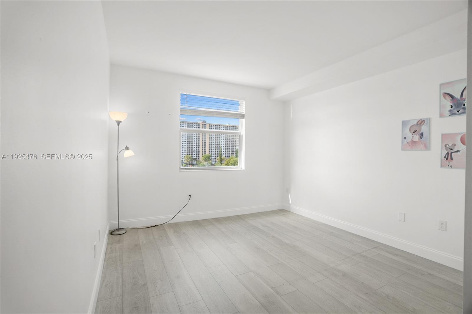 17150 North Bay Road, Unit 2706 Sunny Isles Beach, FL 33160 - Photo 26 of 47 an empty room with wooden floor and windows