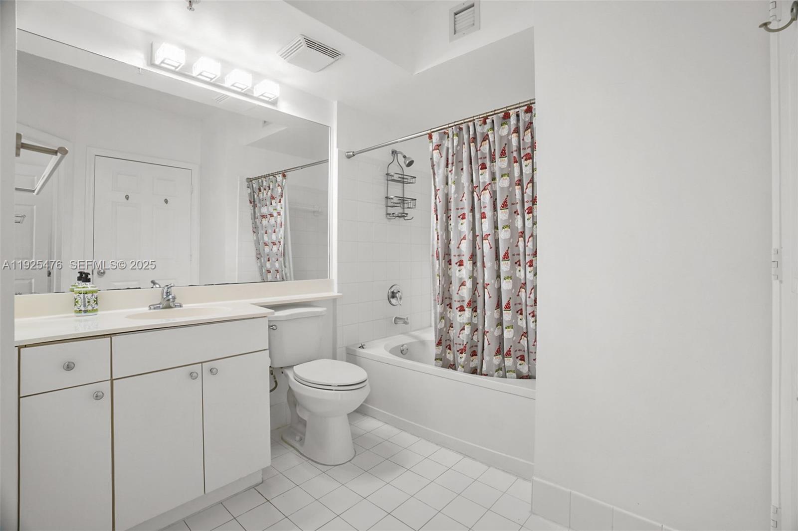 17150 North Bay Road, Unit 2706 Sunny Isles Beach, FL 33160 - Photo 28 of 47 a bathroom with a toilet sink and mirror