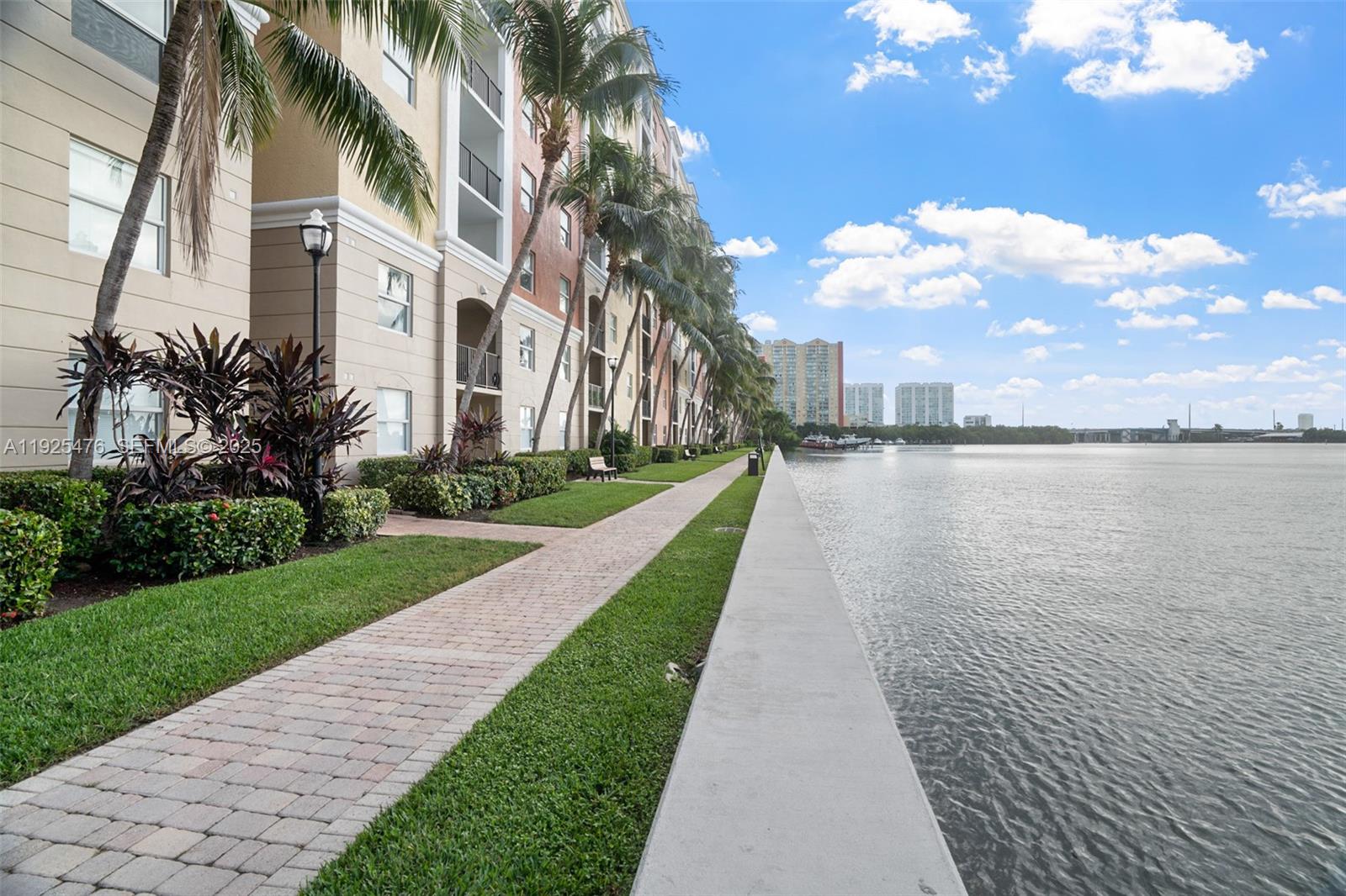 17150 North Bay Road, Unit 2706 Sunny Isles Beach, FL 33160 - Photo 35 of 47 a view of a fountain in front of a brick house next to a yard