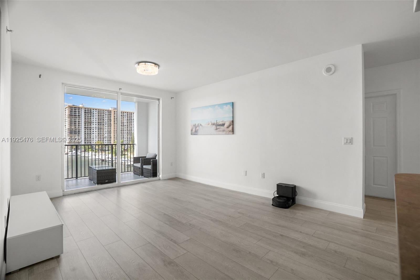 17150 North Bay Road, Unit 2706 Sunny Isles Beach, FL 33160 - Photo 8 of 47 a view of empty room with wooden floor and fan