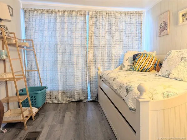 a spacious bedroom with a bed and a chair