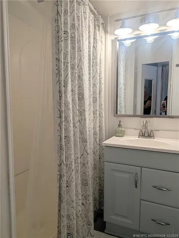 a bathroom with a double vanity sink and mirror