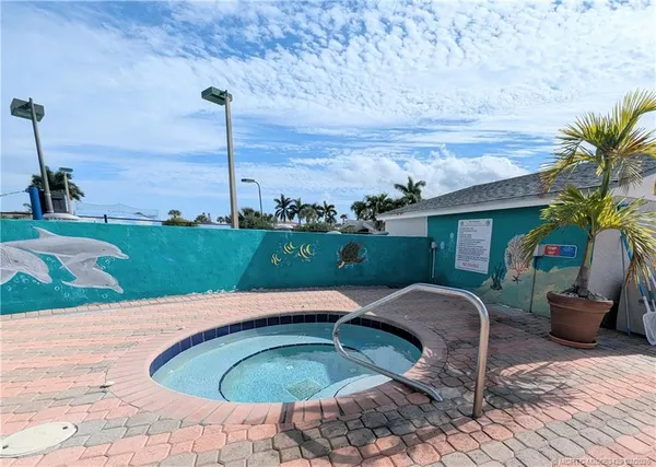 a swimming pool with outdoor seating and garden