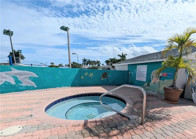 a swimming pool with outdoor seating and garden
