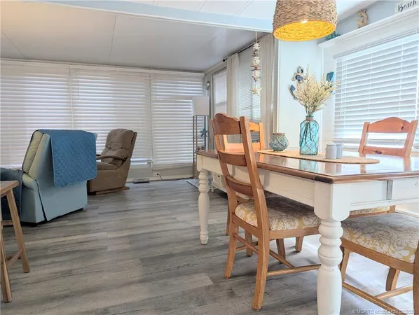 a dining room with furniture and wooden floor