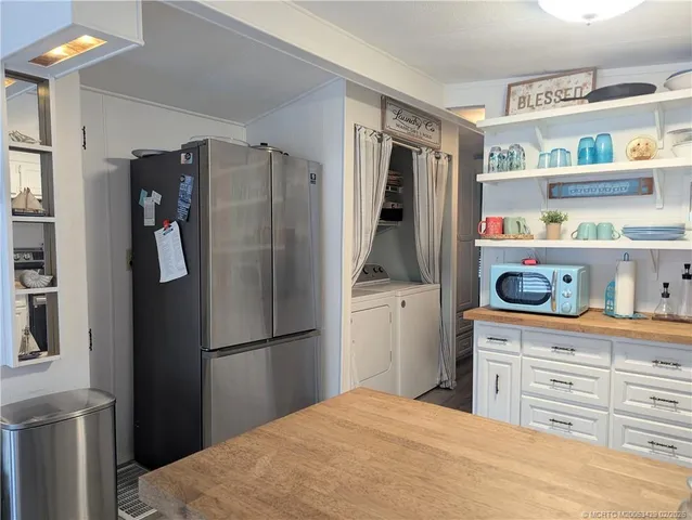 a kitchen with stainless steel appliances a refrigerator and cabinets