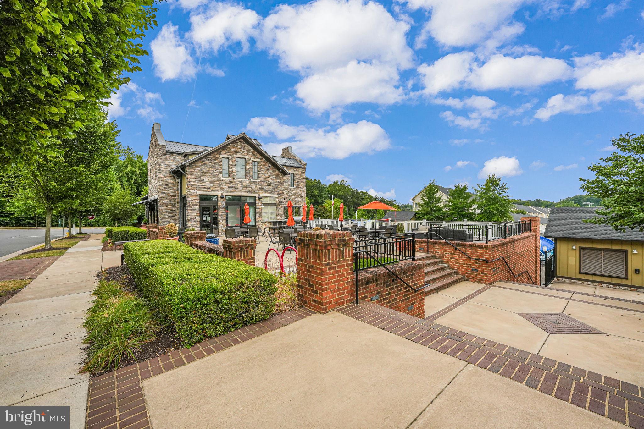 650 Aspen Road, Unit 108 Stafford, VA 22554 - Photo 25 of 26 Charming stone building with lush greenery.