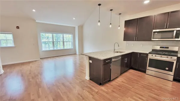 a kitchen with a sink stove and microwave
