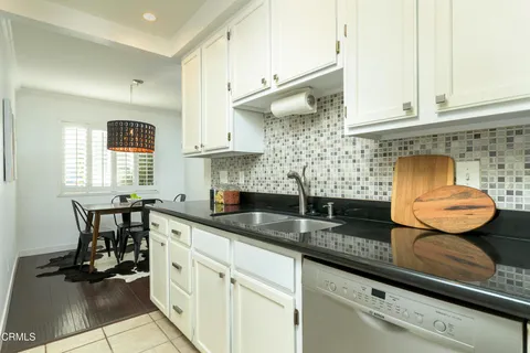 a kitchen with stainless steel appliances granite countertop a sink a stove and cabinets