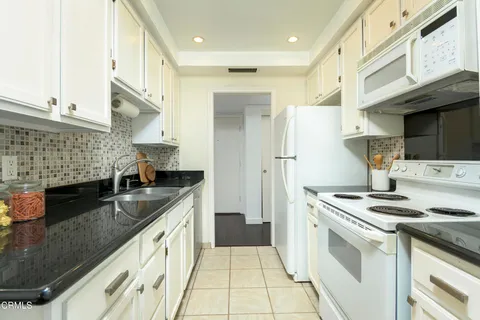 a kitchen with stainless steel appliances granite countertop a sink and a stove