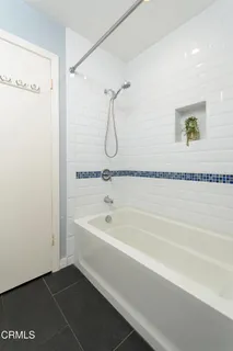 a spacious bathroom with a bathtub and a shower