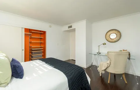 a bedroom with a bed and a chair