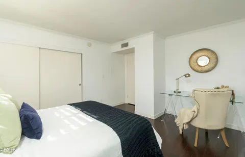 a bedroom with a bed and a table in it
