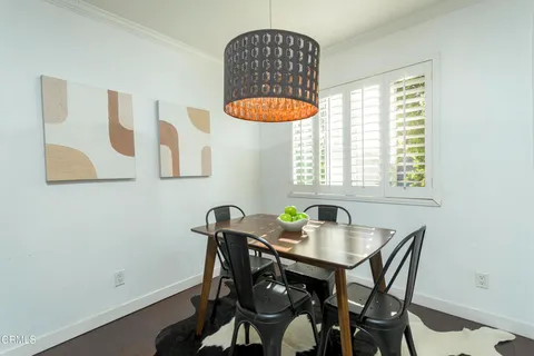 a kitchen with a table and a chair