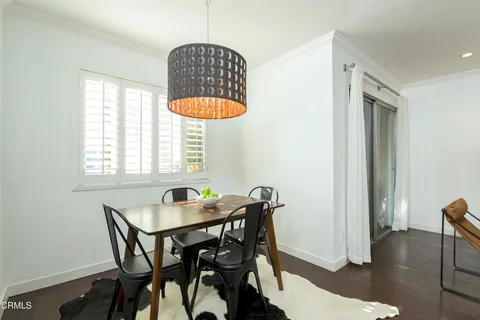 a dining room that has a table and a chandelier