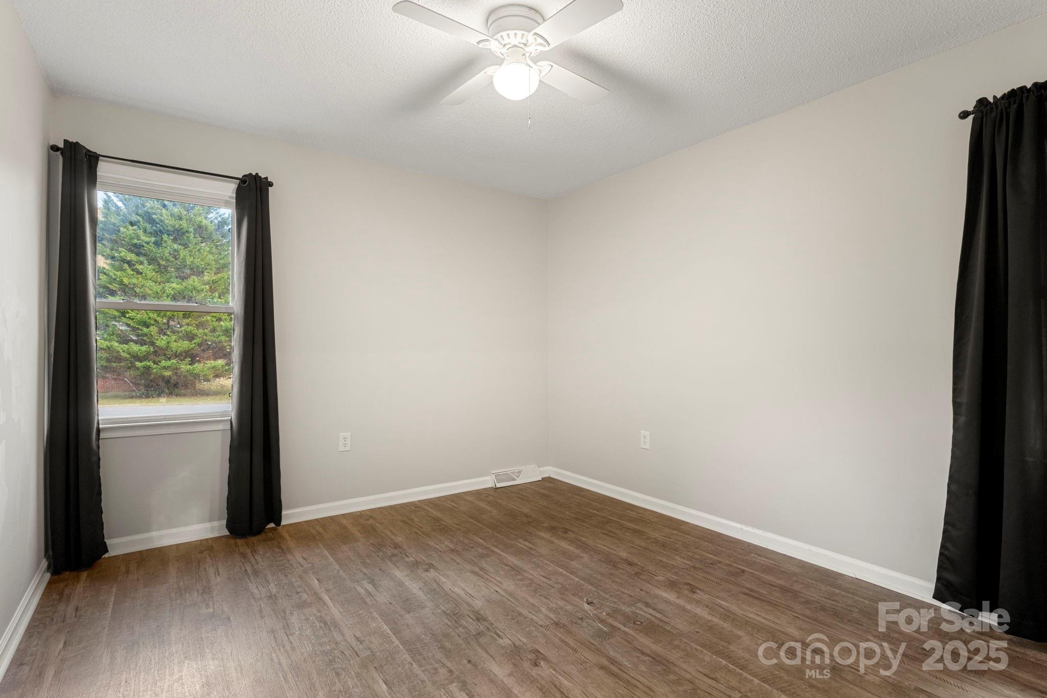 604 Cold Stream Circle Chester, SC 29706 - Photo 13 of 26 an empty room with wooden floor and windows