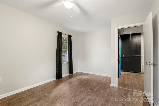 an empty room with wooden floor and closet