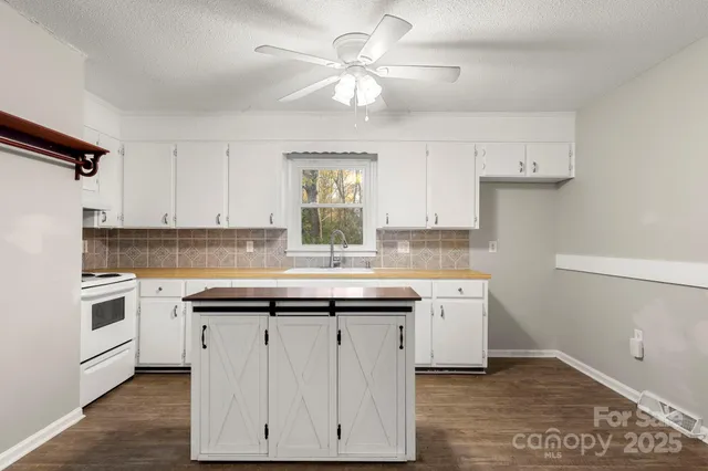 a kitchen with a sink dishwasher a stove and a refrigerator