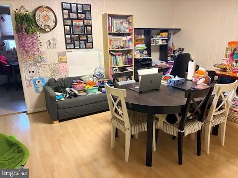 a living room with furniture a rug and a bookshelf
