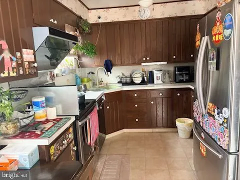 a kitchen with stainless steel appliances granite countertop a sink and a refrigerator