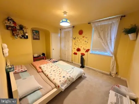 a bedroom with a bed and a mirror