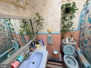 a bathroom with a toilet mirror vanity and toilet