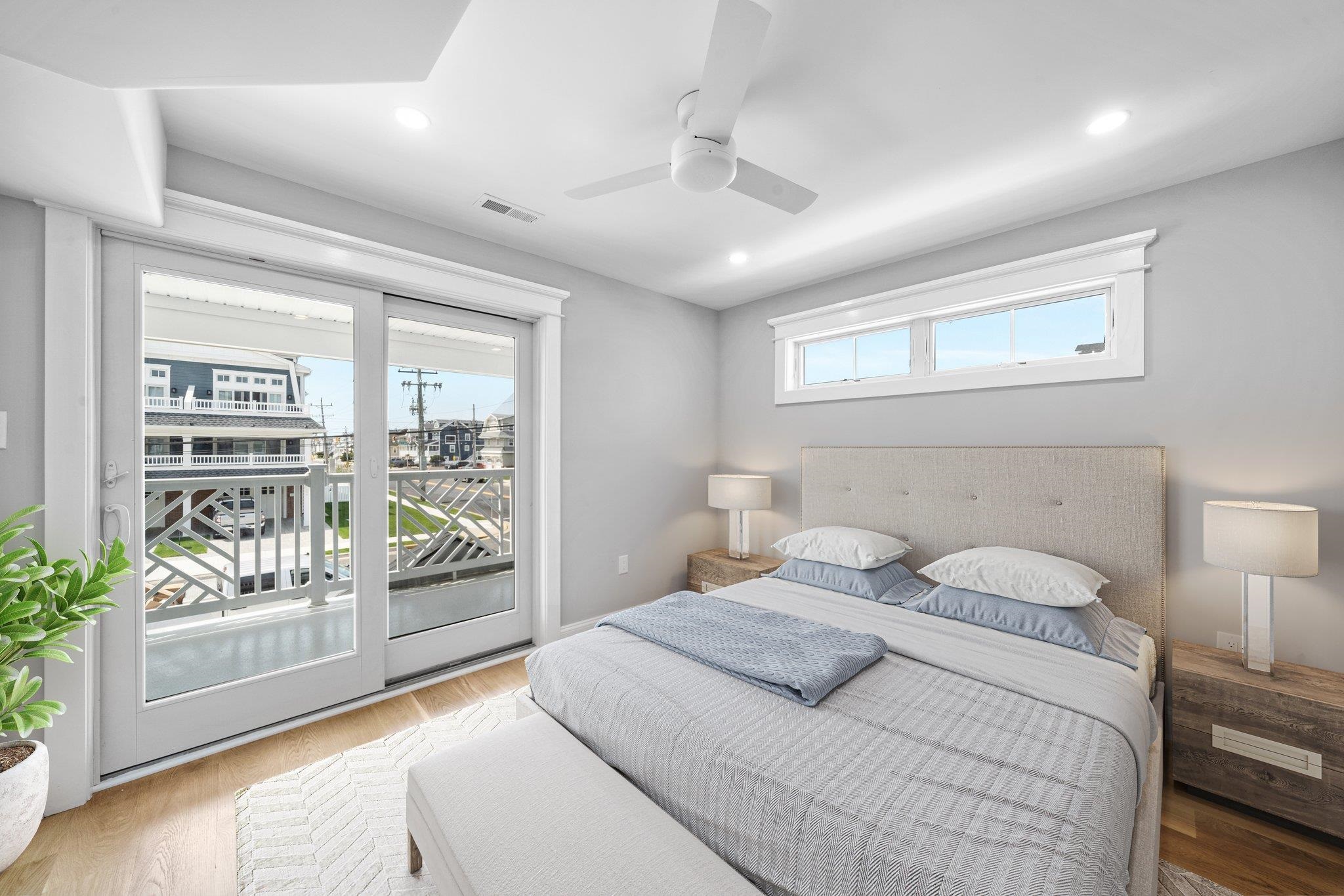 297 24th, Unit 297 Avalon, NJ 08202 - Photo 13 of 49 a bedroom with a balcony and large window