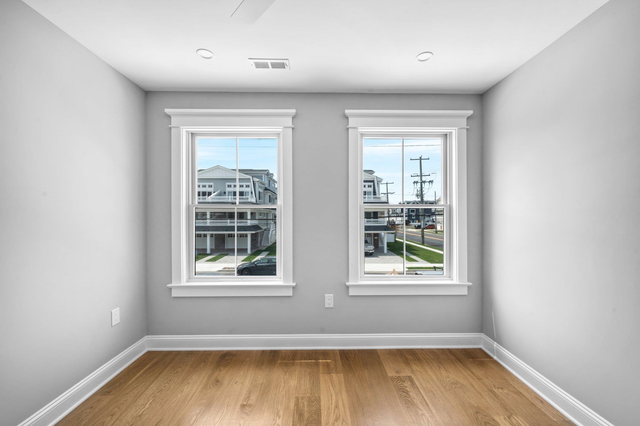297 24th, Unit 297 Avalon, NJ 08202 - Photo 16 of 49 an empty room with wooden floor and windows