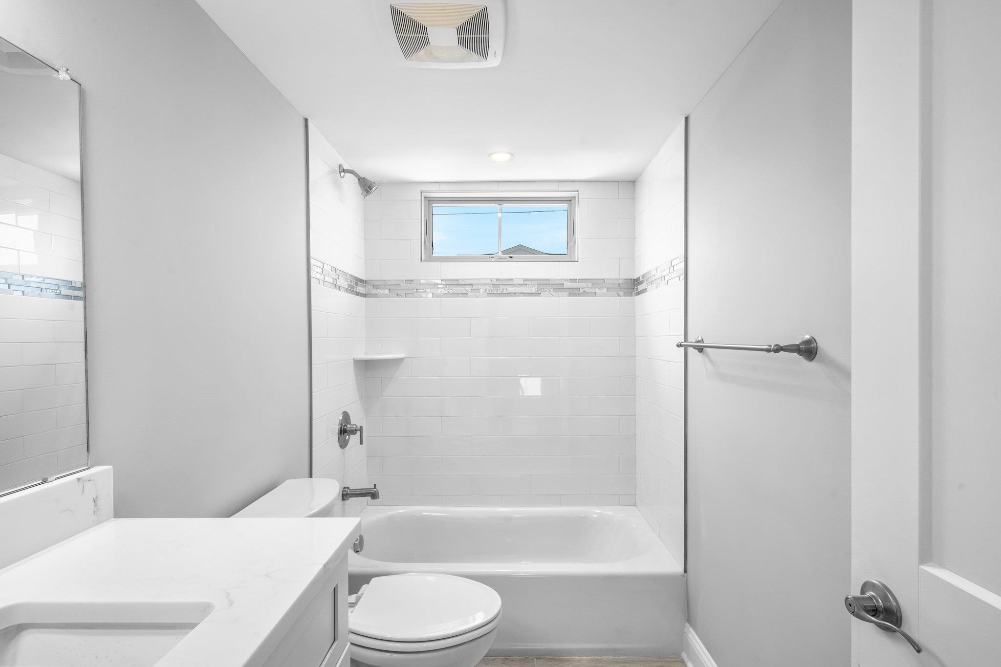 297 24th, Unit 297 Avalon, NJ 08202 - Photo 20 of 49 a bathroom with a granite countertop bathtub shower sink vanity and toilet