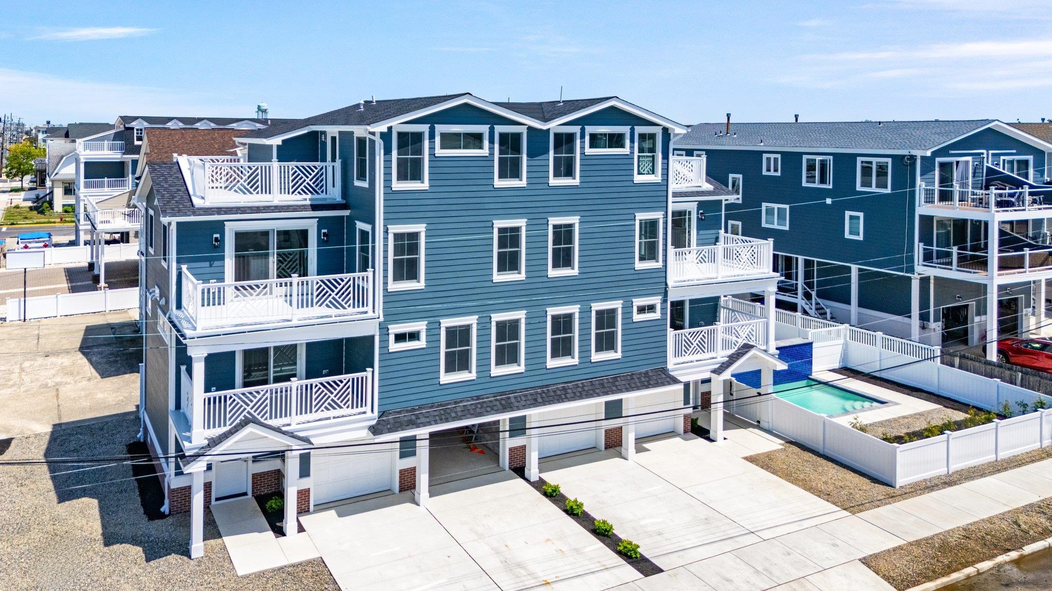 297 24th, Unit 297 Avalon, NJ 08202 - Photo 2 of 49 a front view of a building with many windows