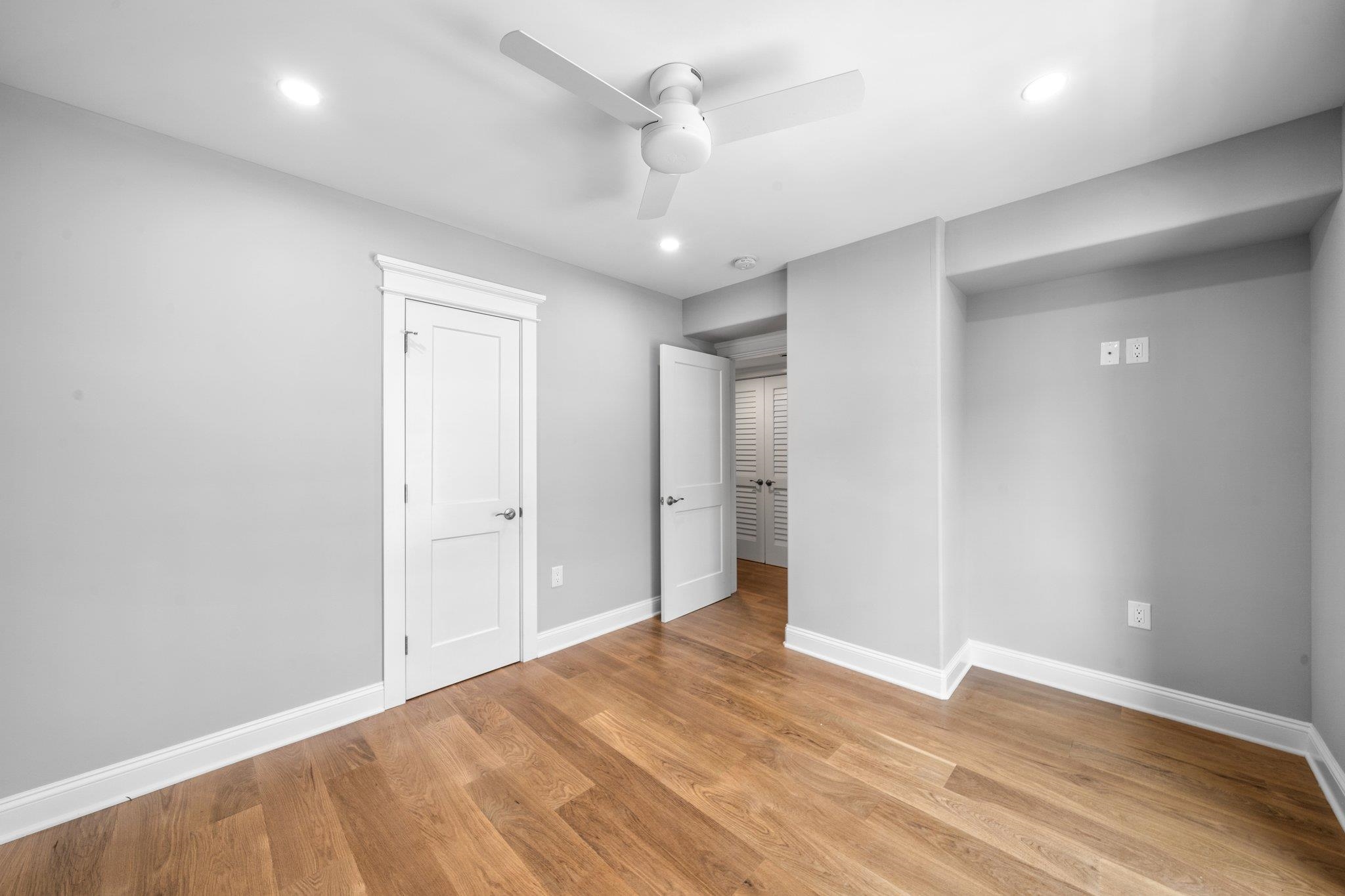 297 24th, Unit 297 Avalon, NJ 08202 - Photo 22 of 49 an empty room with wooden floor and ceiling fan